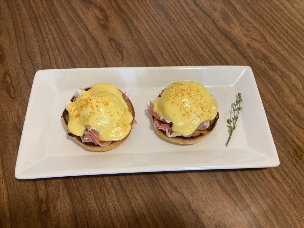 白い皿に並ぶ2つのエッグベネディクト